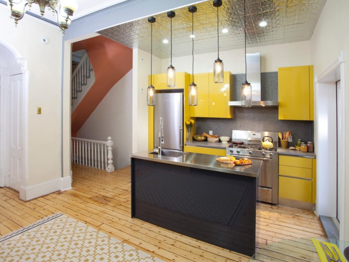 small modern colorful one-unit kitchen in yellow and metallic