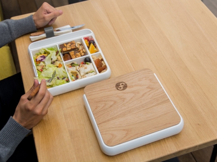 Ceramic Lunch Container with wooden lit on a table man eating