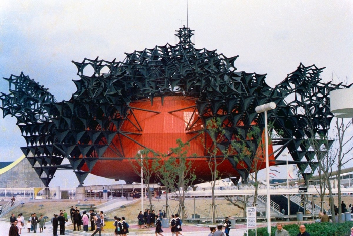 Interesting Japanese building in red with modern architecture and black roof 