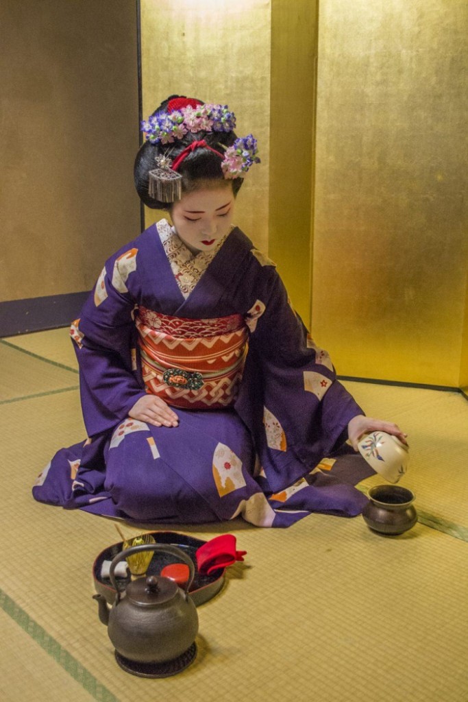 Japanese girl in traditional clothes doing Tea ceremony 