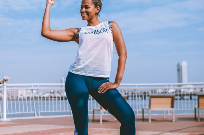 woman in sporting clothes showing muscles 