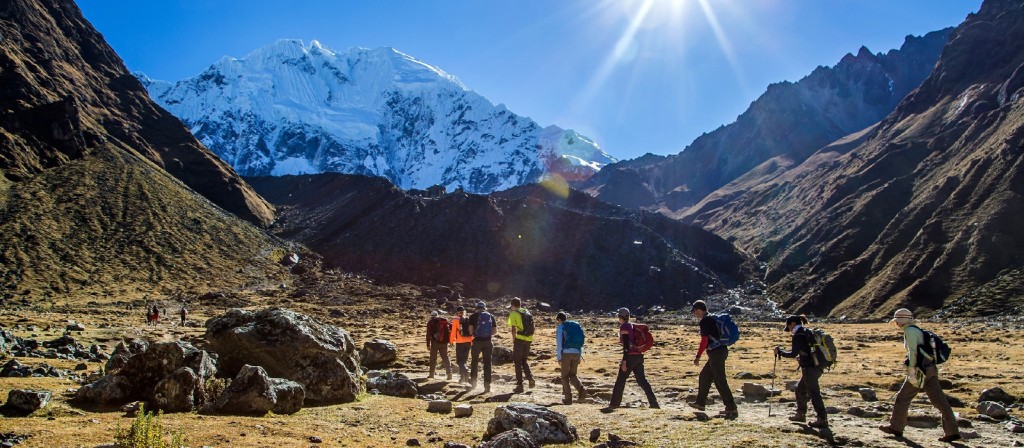 A group of hikers walking together in a valley snowy mountain
