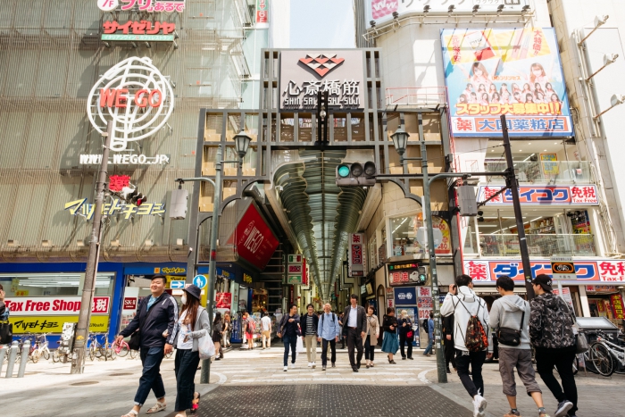 Tourists walking in front of a large mall in Japan