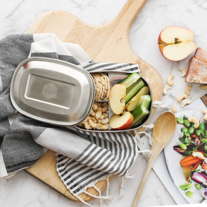 Stainless Steel Adult Lunch Box healthy meal with vegetables nuts and fruits on a kitchen table