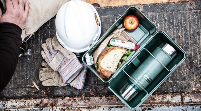 Stainless steel lunch box with sandwich and apple worker at work 