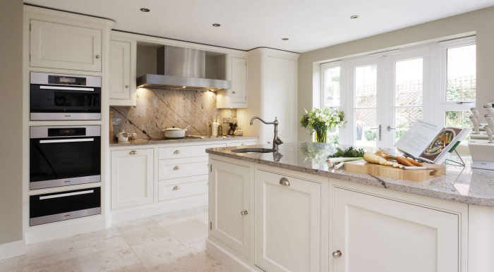 traditional white kitchen with a kitchen island and marble countertop