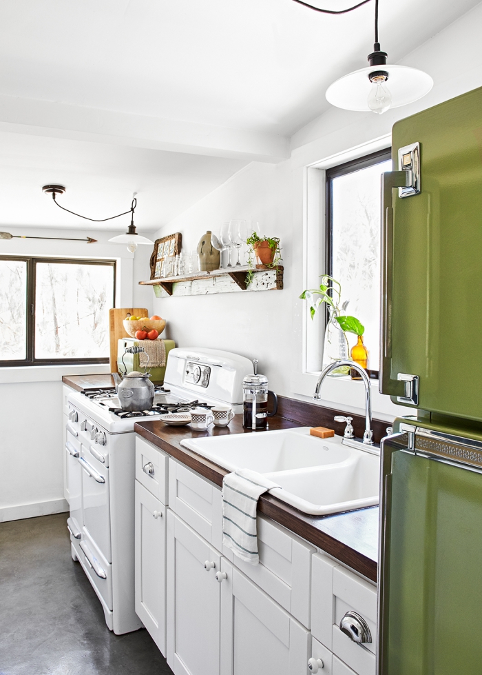 small white kitchen with green refrigerator low ceiling