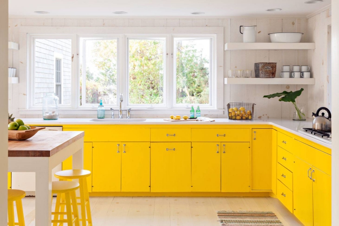 bright yellow and white kitchen with large windows