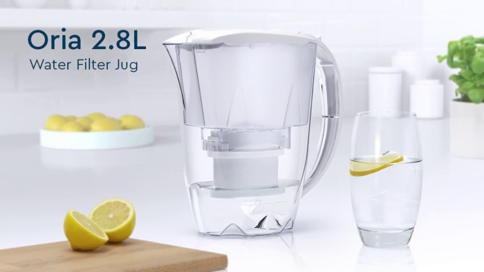 Water filter jug on a table glass lemon slices