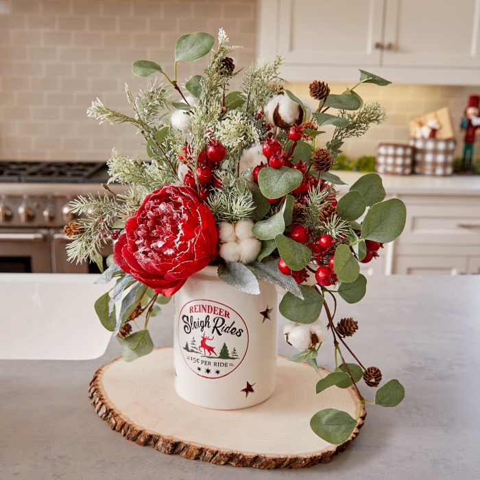 Beautiful Floral Christmas table centerpiece red flowers cotton berries leaves in a kitchen