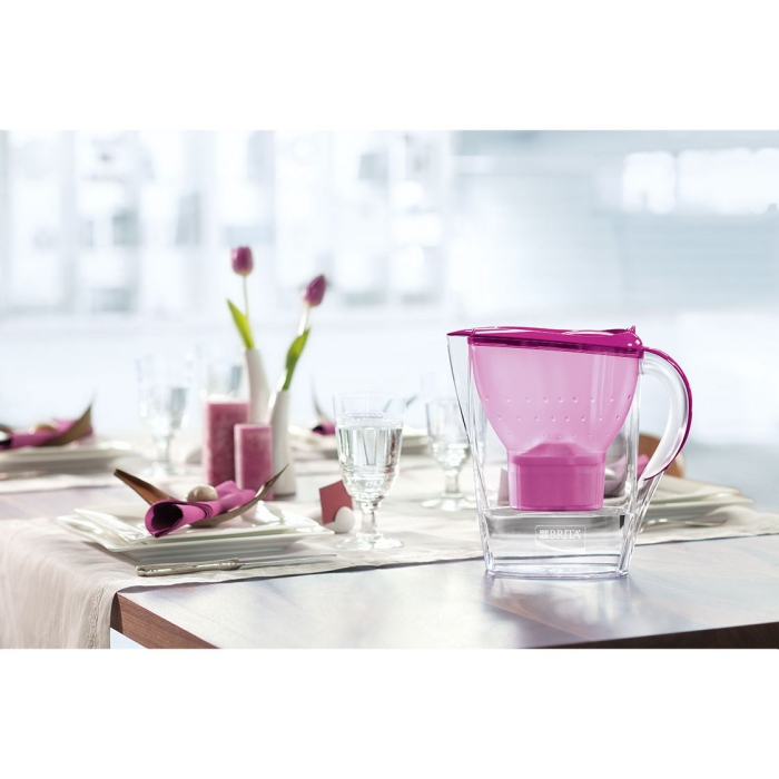 Water filter jug pink inside on a table