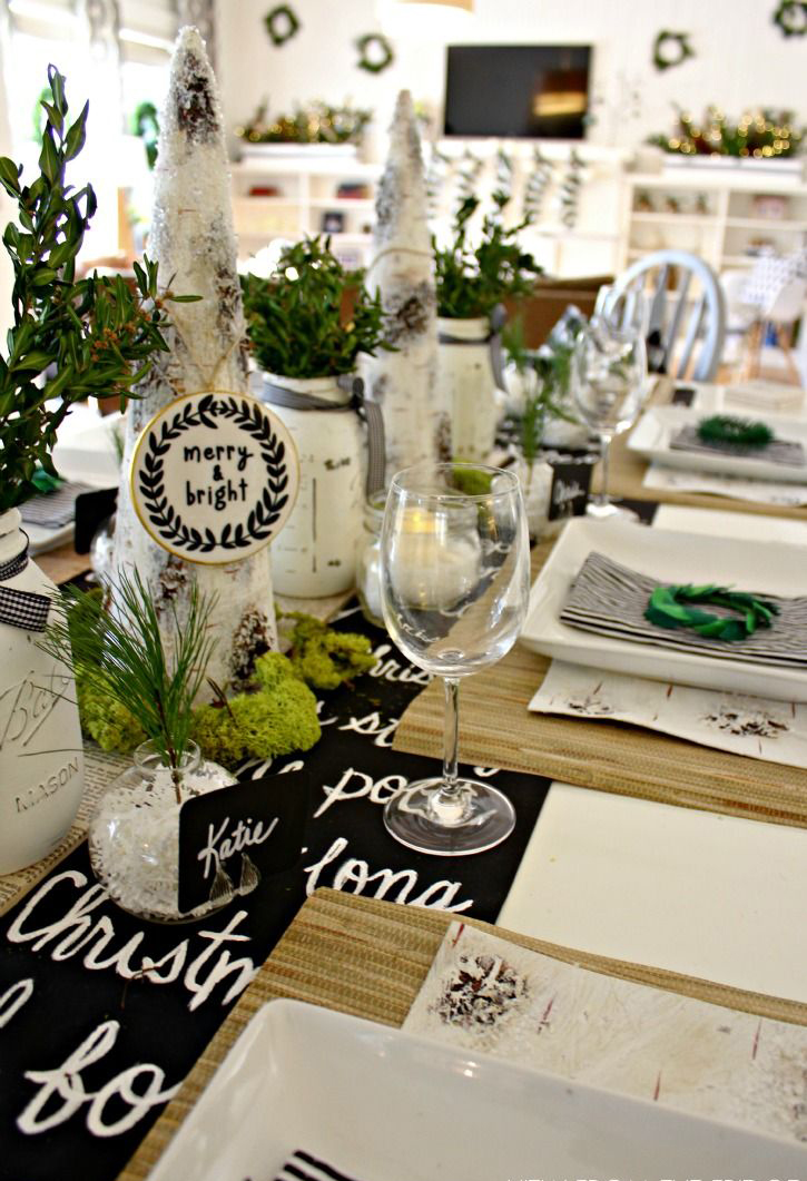 Natural Christmas table decor greens and wood table close up