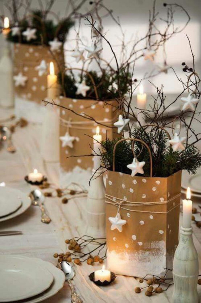 Christmas table centerpiece idea stars gift bags branches candles