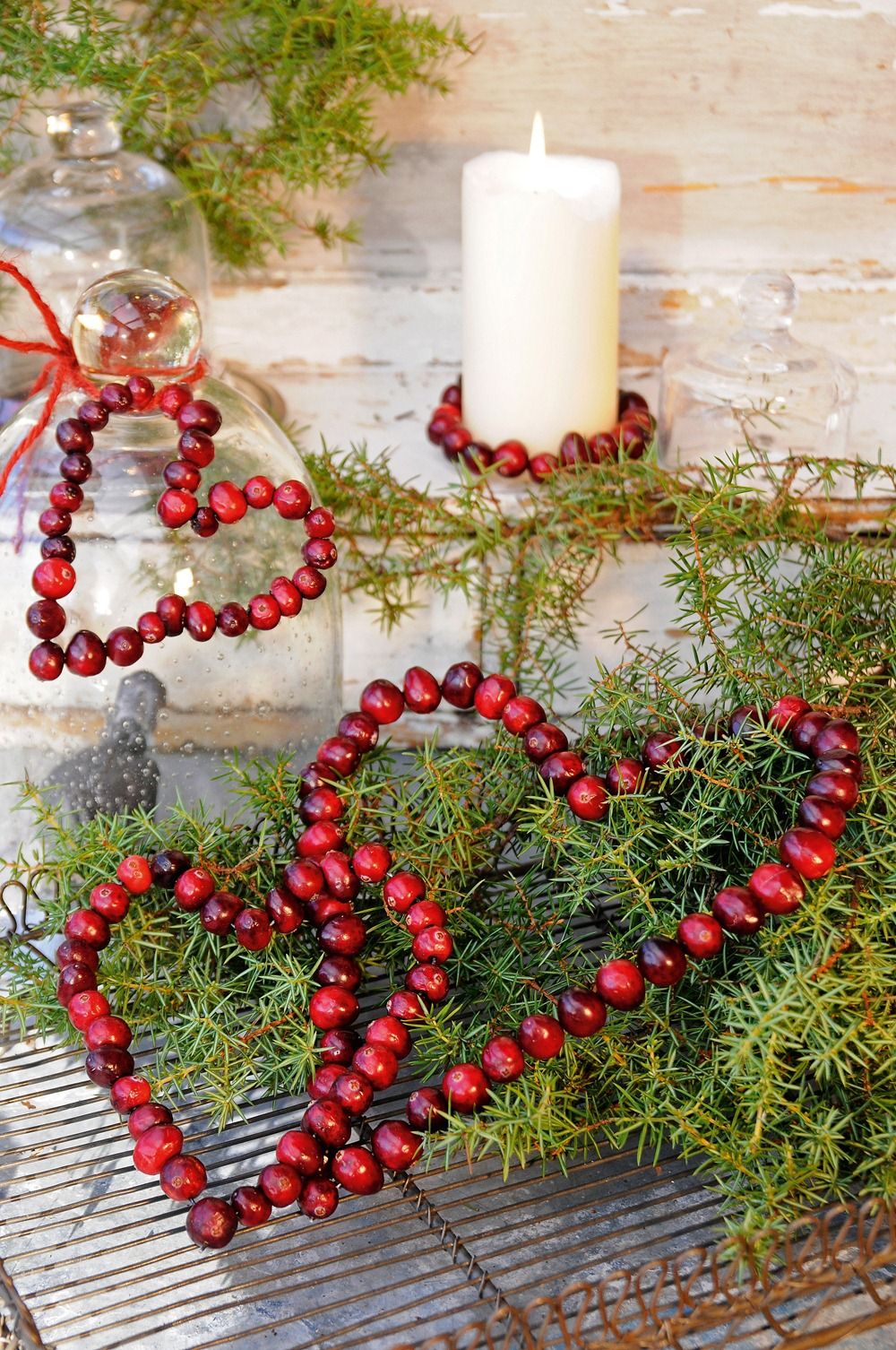 Cranberry Christmas hearts decorations green branches candle