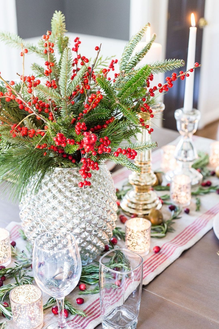 Floral Christmas table centerpiece glass vase berries evergreen branches candles