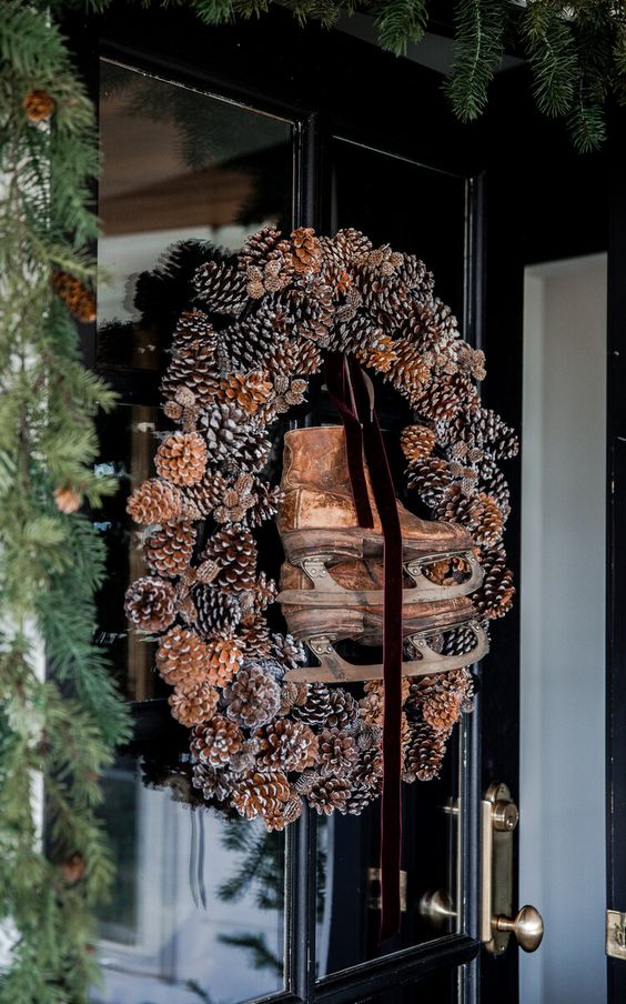 front door natural wreath pinecones vintage ice skates