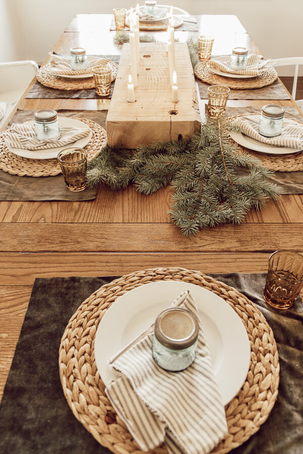 Wooden table decorated with natural elements evergreen branches wooden candleholder