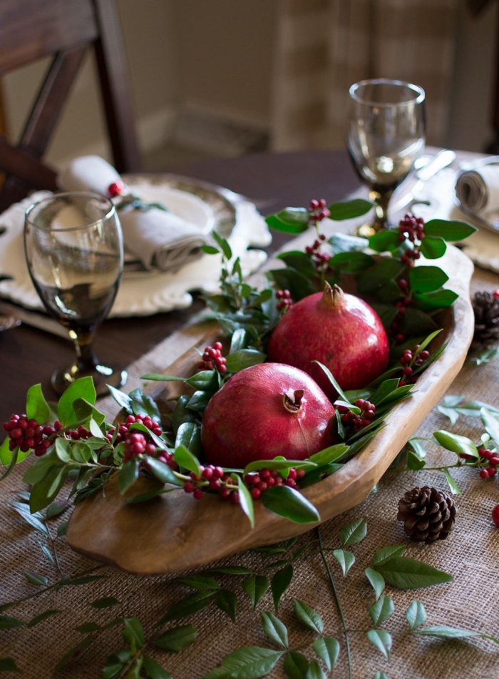 Natural Christmas table centerpiece pomegranates berries green leaves