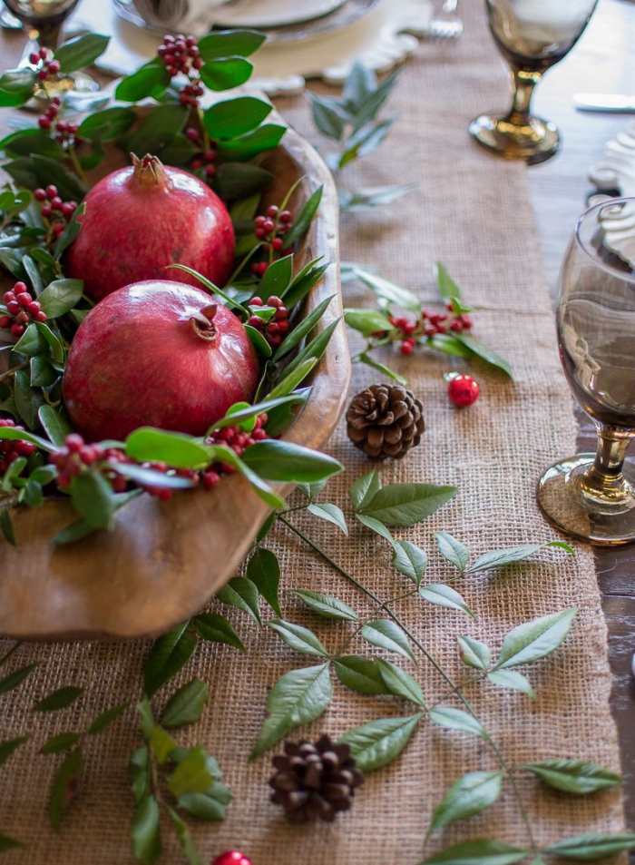 Natural table decor for Christmas centerpiece pomegranate berries green leaves