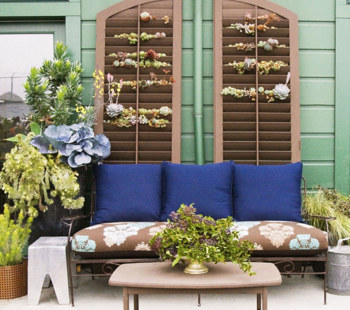 Elegant patio with plants brightly colored seating area coffee table