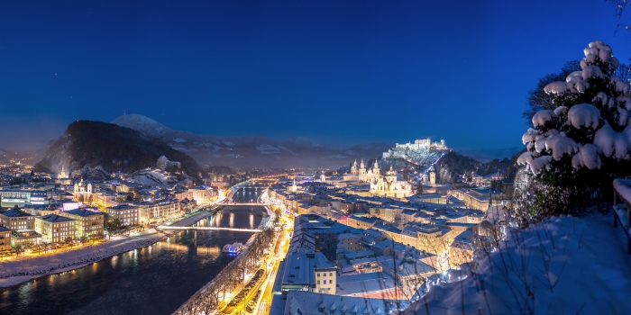 View on snowy Salzburg from above street lights