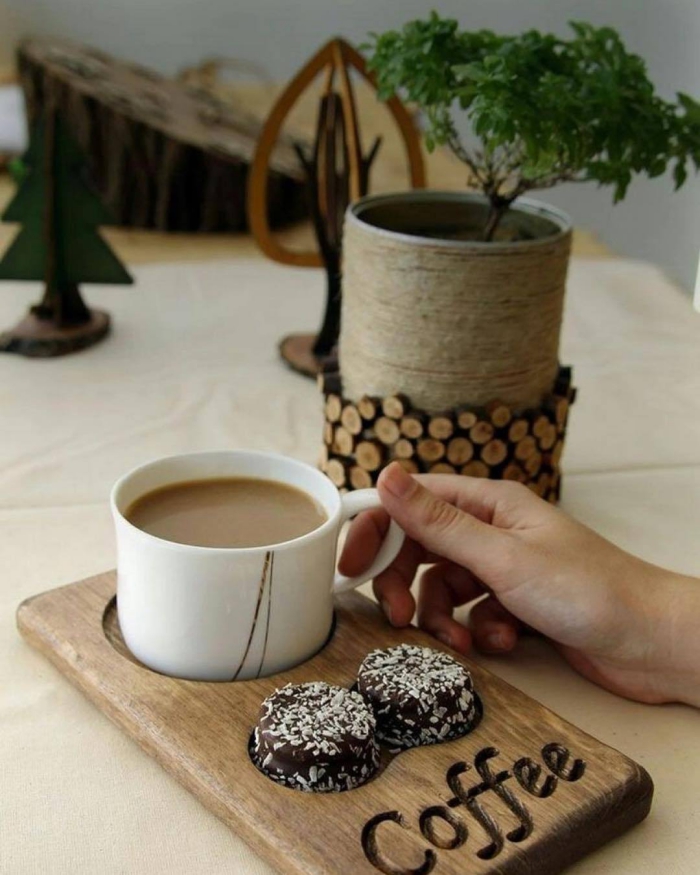 Cute wooden serving tray cup of coffee and two sweets wooden items 