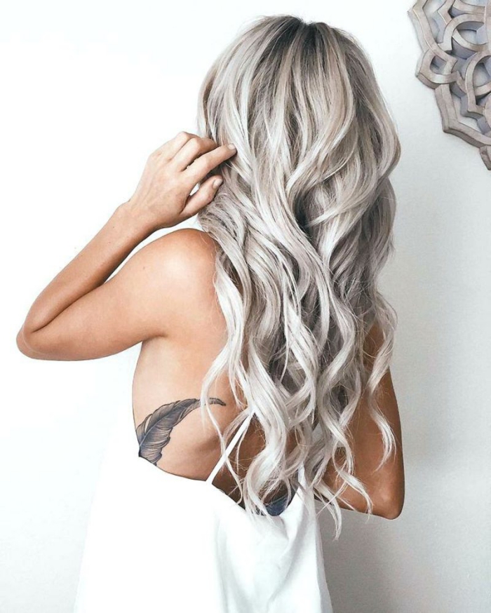 balayage hair colors woman back long silver blond hair waves white background tattoo