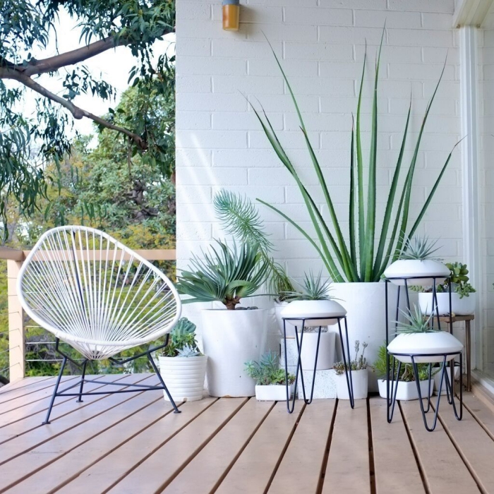 Small patio in white with potted plants minimalist furniture metal chair