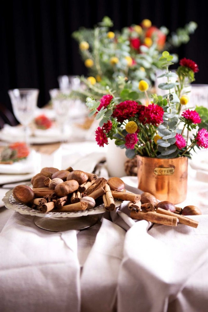 cinnamon and chestnuts table decorations vases with flowers