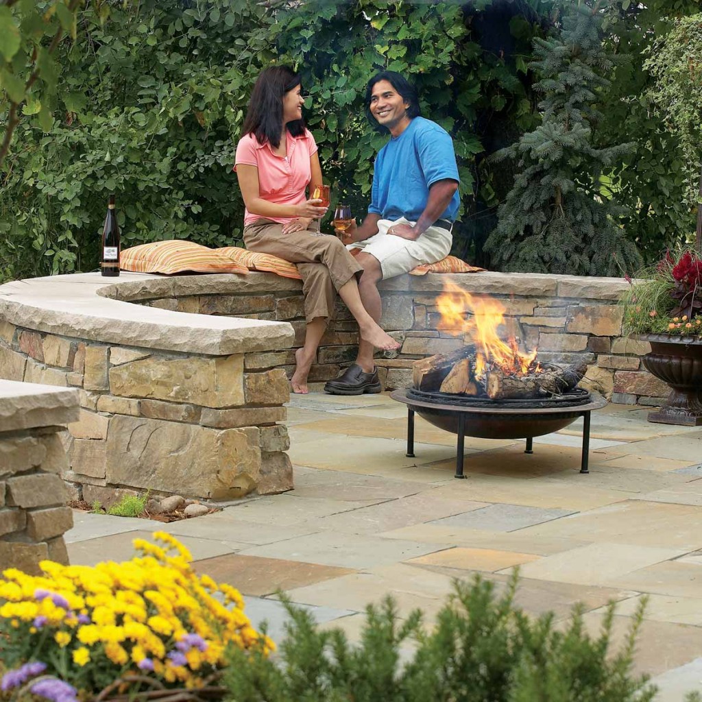 Patio stone walls couple enjoying wine fire pit