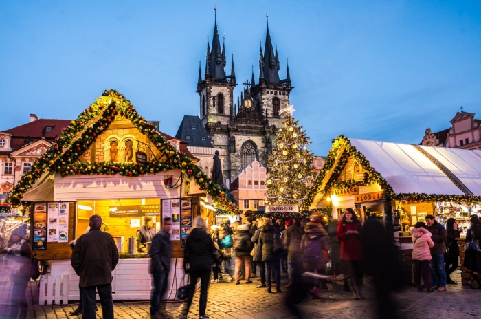 busy Prague Christmas market main square old cathedral decorated stands