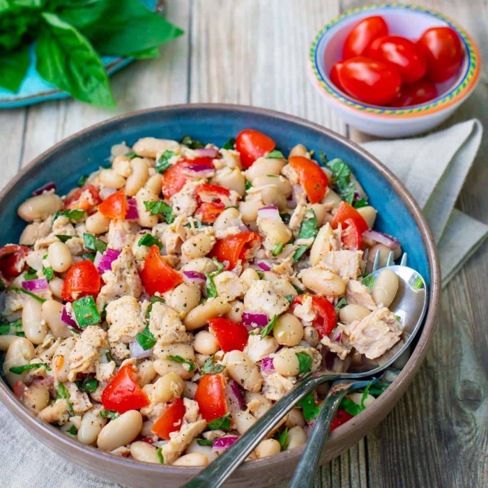 Tuna and vegetables dish in a plate with cuttlery on a table