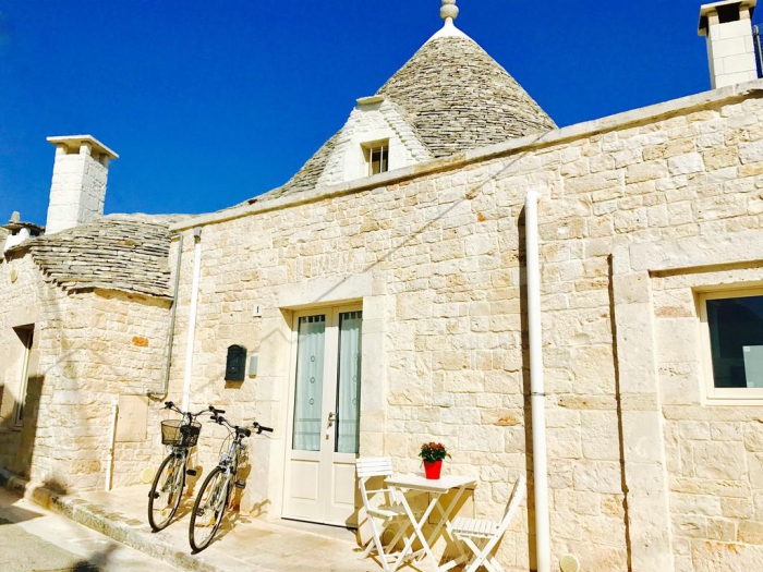 Modern trullo architecture two bycicles stone walls