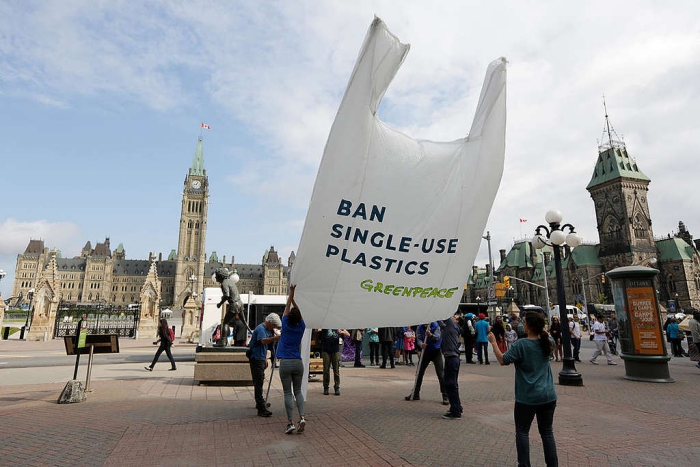 single-use plastic ban greenpeace city landscape big plastic bag