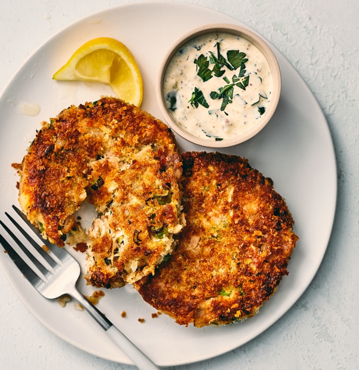 Low carb tuna cakes with a fork piece of lemon and a dip