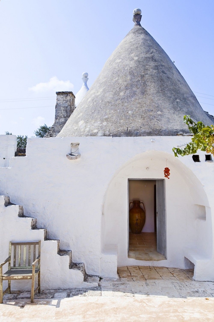 trullo architecture white trullo entrance staircase old chair