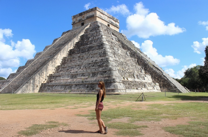 Chichén Itzá woman in front of a pyramid mayan ruins mexican riviera