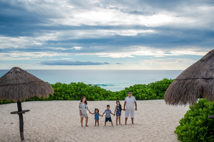 Playa Delfines Cancun family photo family of five white beach greenery