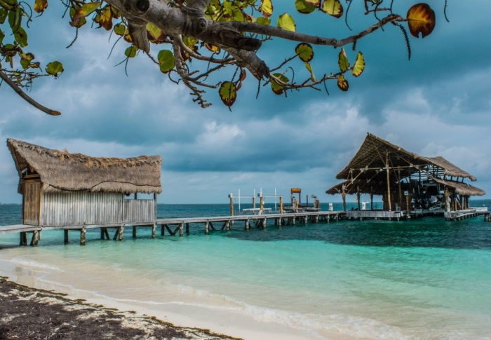 Playa Tortugas Things to do in Cancun Mexico wooden buildings bay beach clear blue water