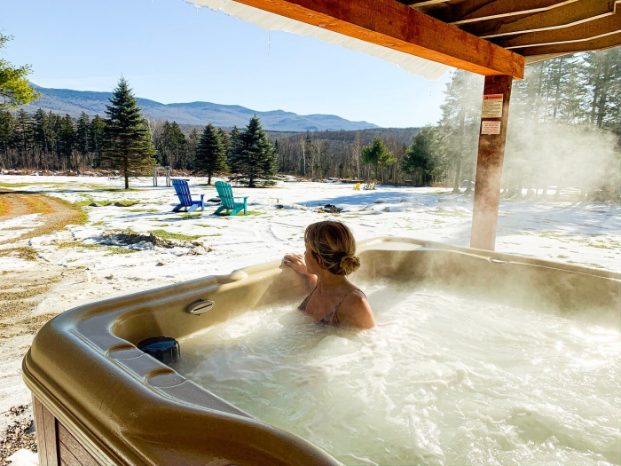 woman in an outdoor hot spa snowy landscape