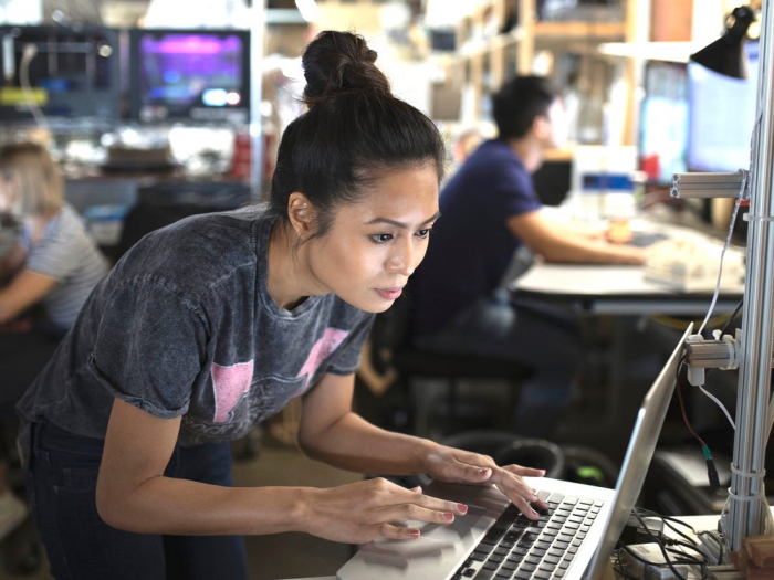 woman software engineer in an office on a computer 