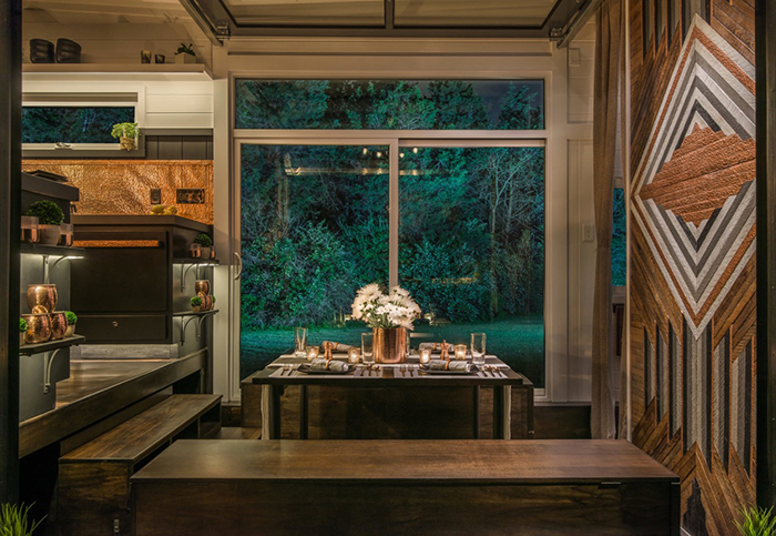 Luxurious tiny home interior dining table in front of a window