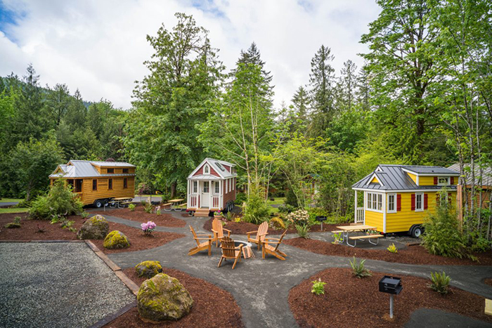 tiny house communities three colorful houses in a forest 
