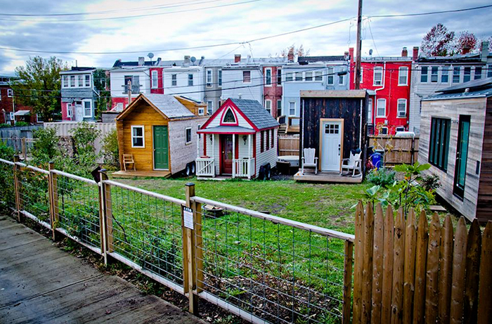 tiny house community three small colorful houses with a small garden