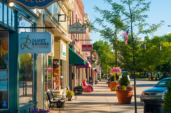 Small town shops side street green trees