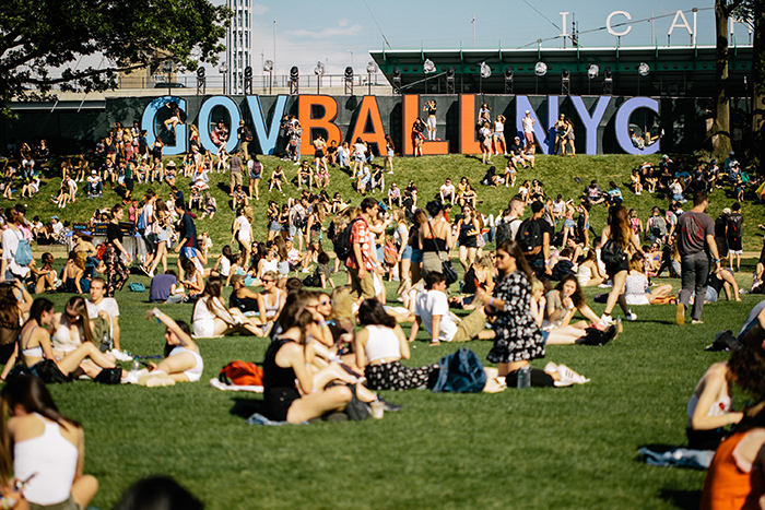 Governors Ball New York People sitting outside in the sun crowded outdoor space