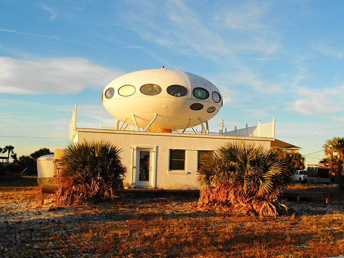 Futuro house exterior on the roof of a building white UFO-shaped home