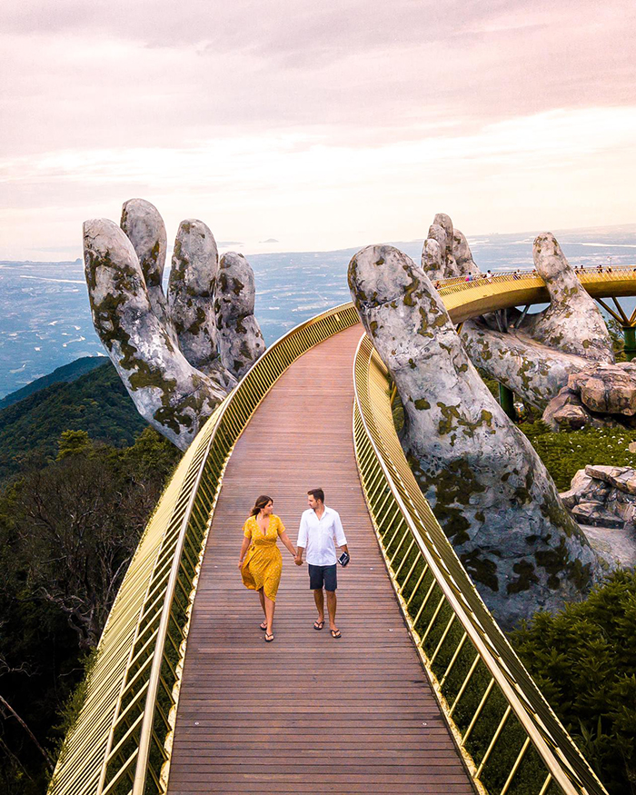 Couple holding hands Golden Bridge Vietnam Hands in the background