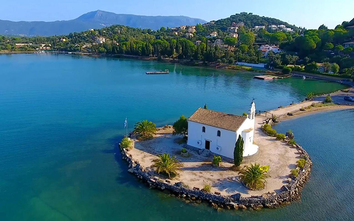 island in Greece with a church blue sea white church island for sale
