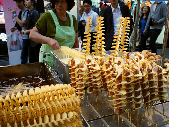 Korean Street food tornado potatoes woman selling potato spirals on the street